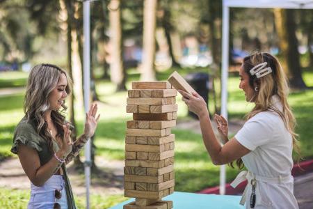 Female students building blocks together.